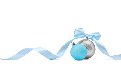 Photo of Beautiful Christmas balls and ribbon isolated on white