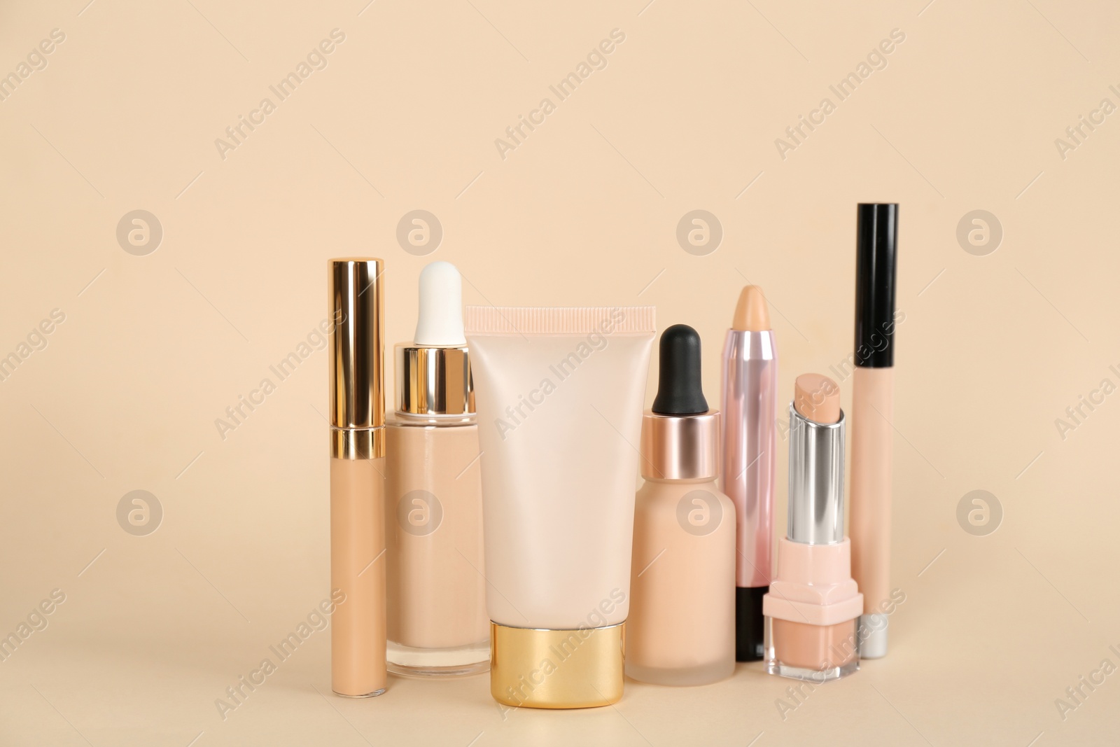 Photo of Foundation makeup products on beige background. Decorative cosmetics