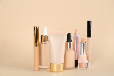 Foundation makeup products on beige background. Decorative cosmetics