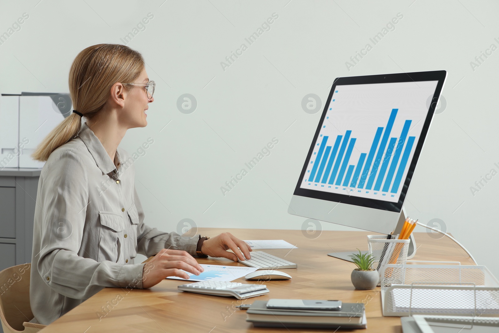 Photo of Professional accountant working at wooden desk in office