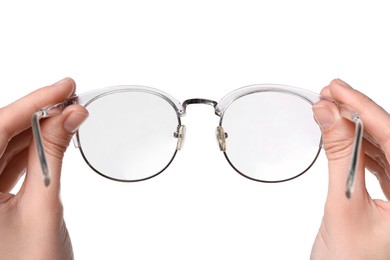 Photo of Woman holding stylish glasses with transparent frame on white background, closeup