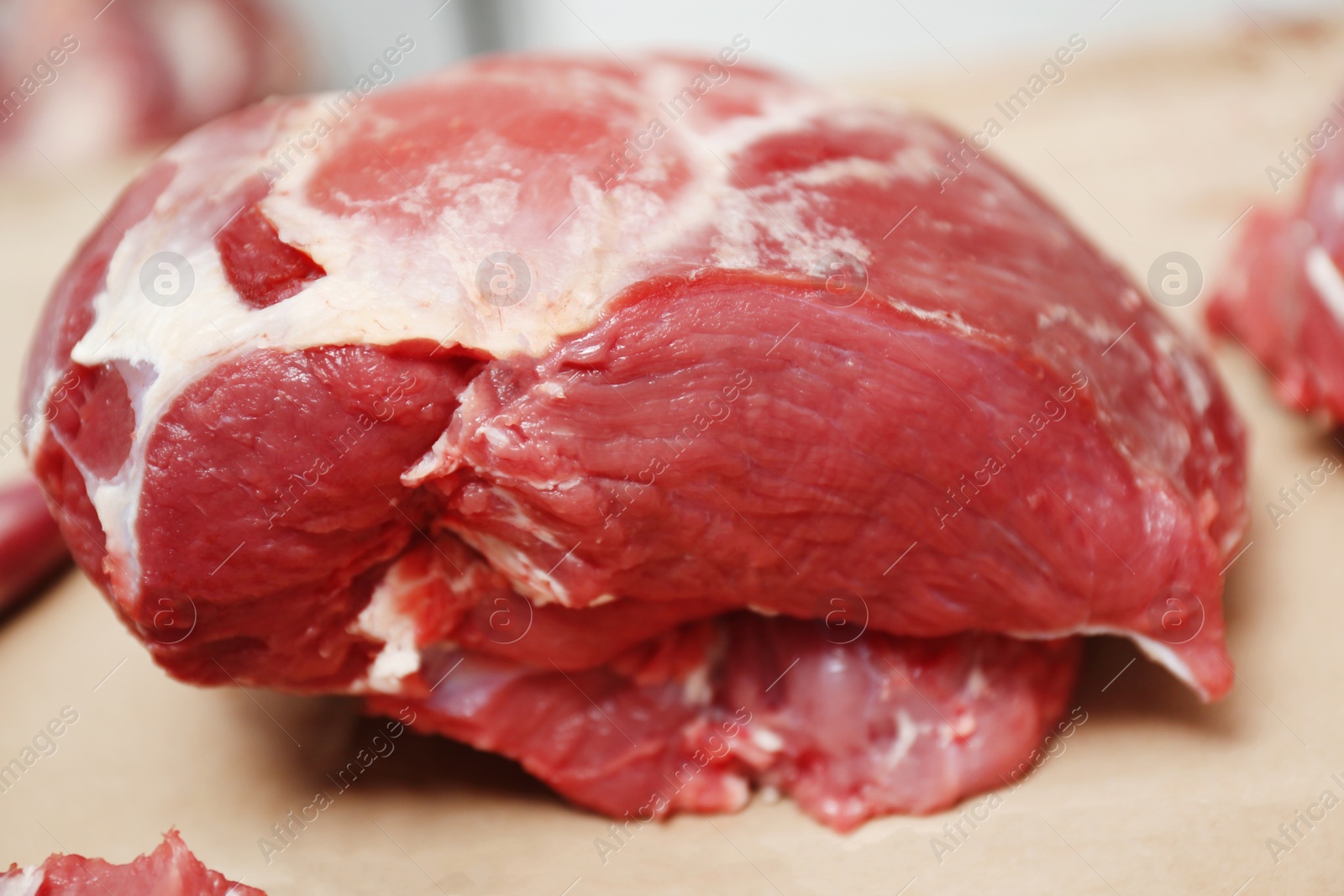 Photo of Pieces of fresh raw meat on counter in butcher shop