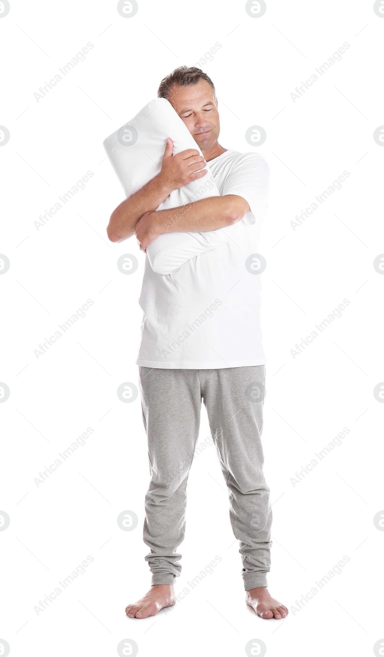 Photo of Man holding soft pillow on white background