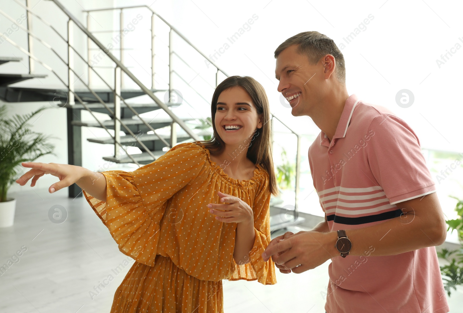 Photo of Man and woman having conversation in hall