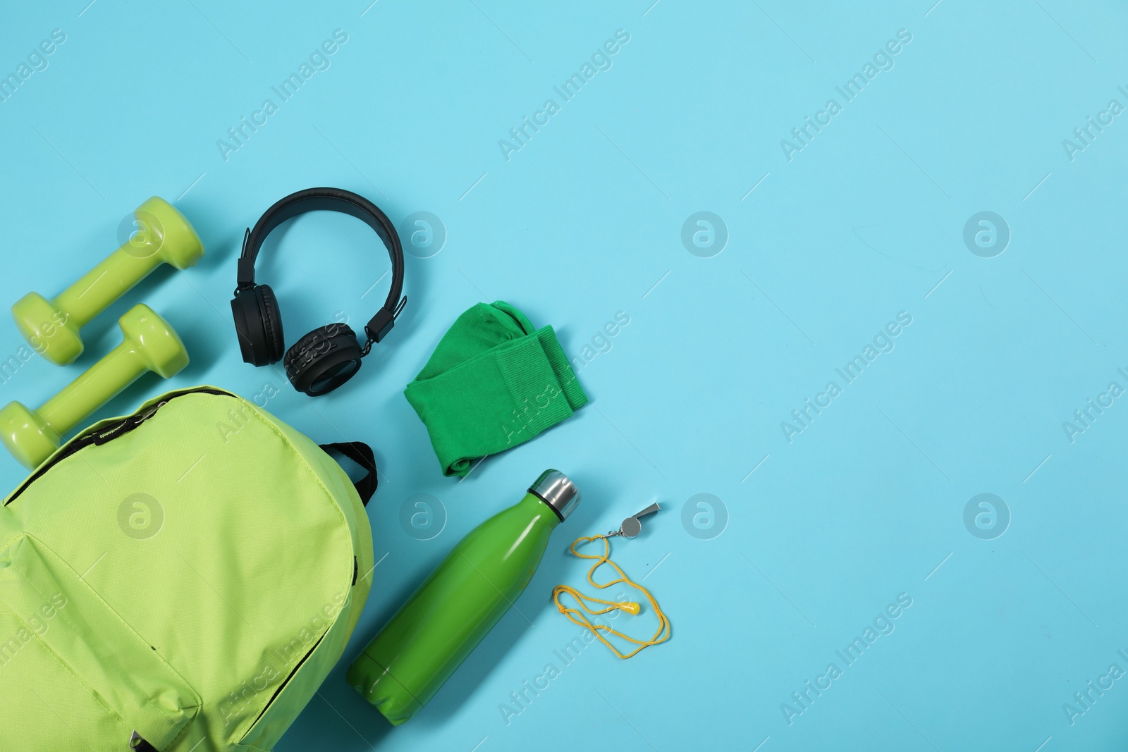 Photo of Different sports equipment on light blue background, flat lay. Space for text