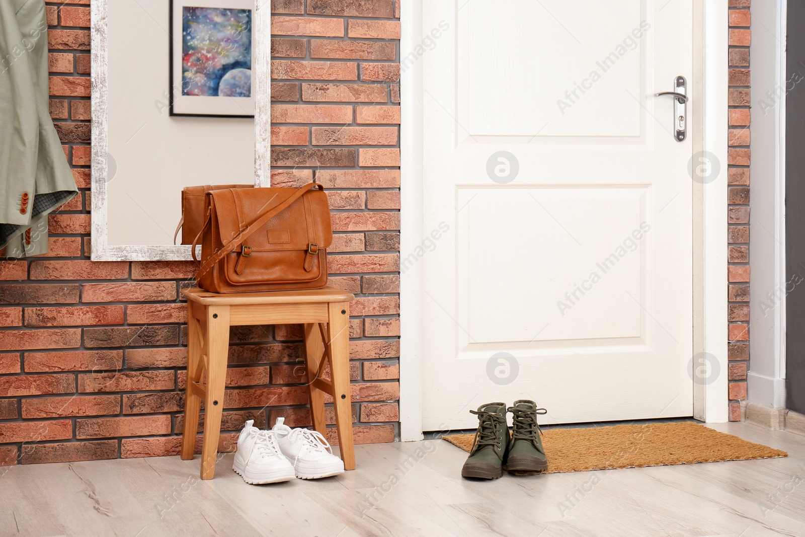 Photo of Hallway interior with shoes, mirror and mat near door