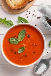 Photo of Flat lay composition with delicious tomato cream soup in bowl on white wooden table