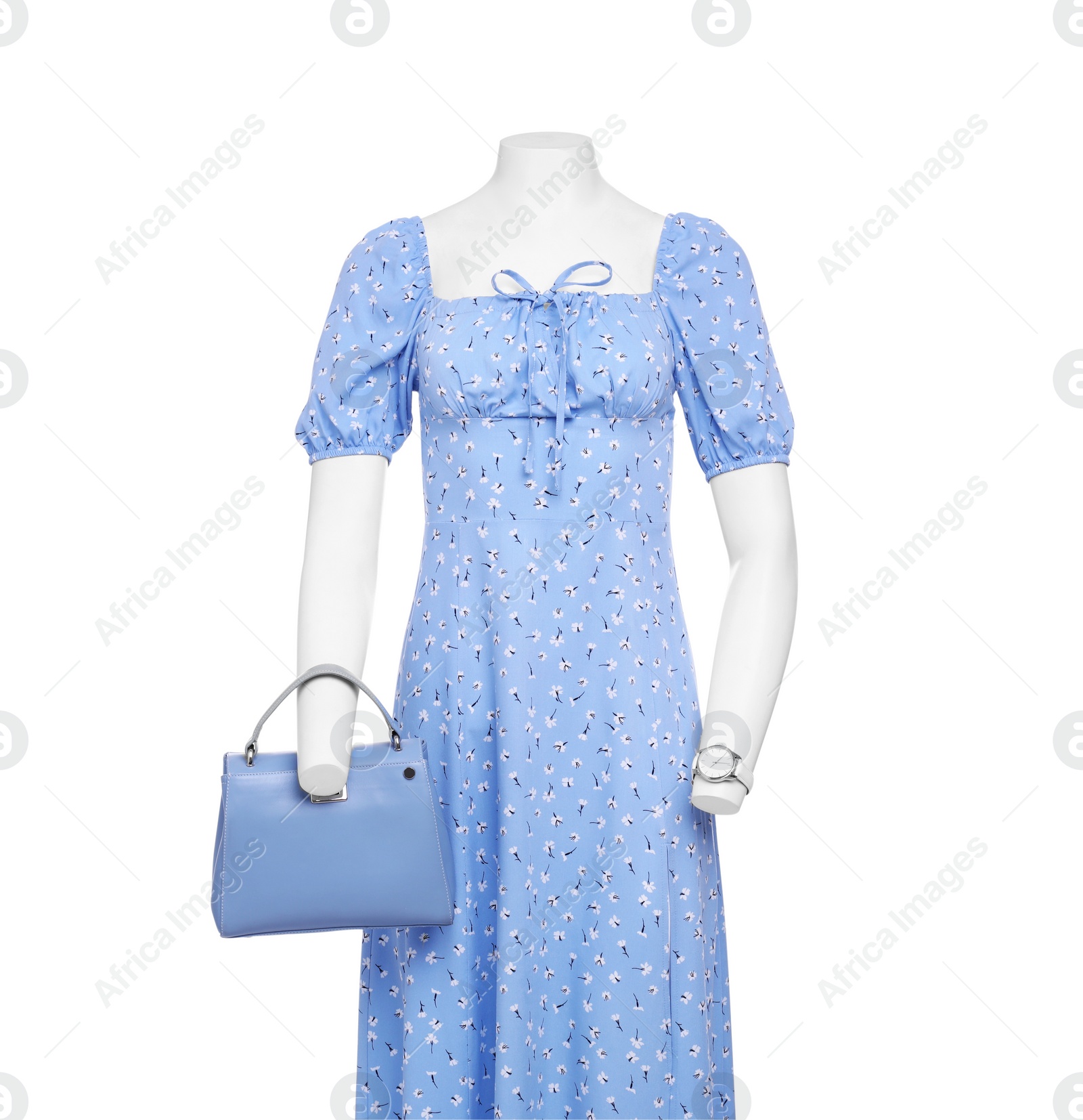 Photo of Female mannequin with accessories dressed in stylish light blue dress isolated on white