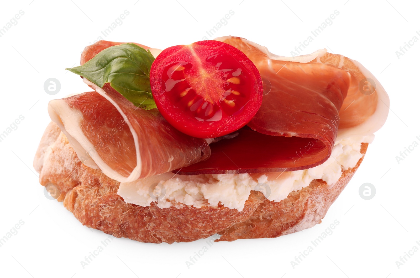 Photo of Tasty sandwich with cured ham, tomato and basil leaf isolated on white