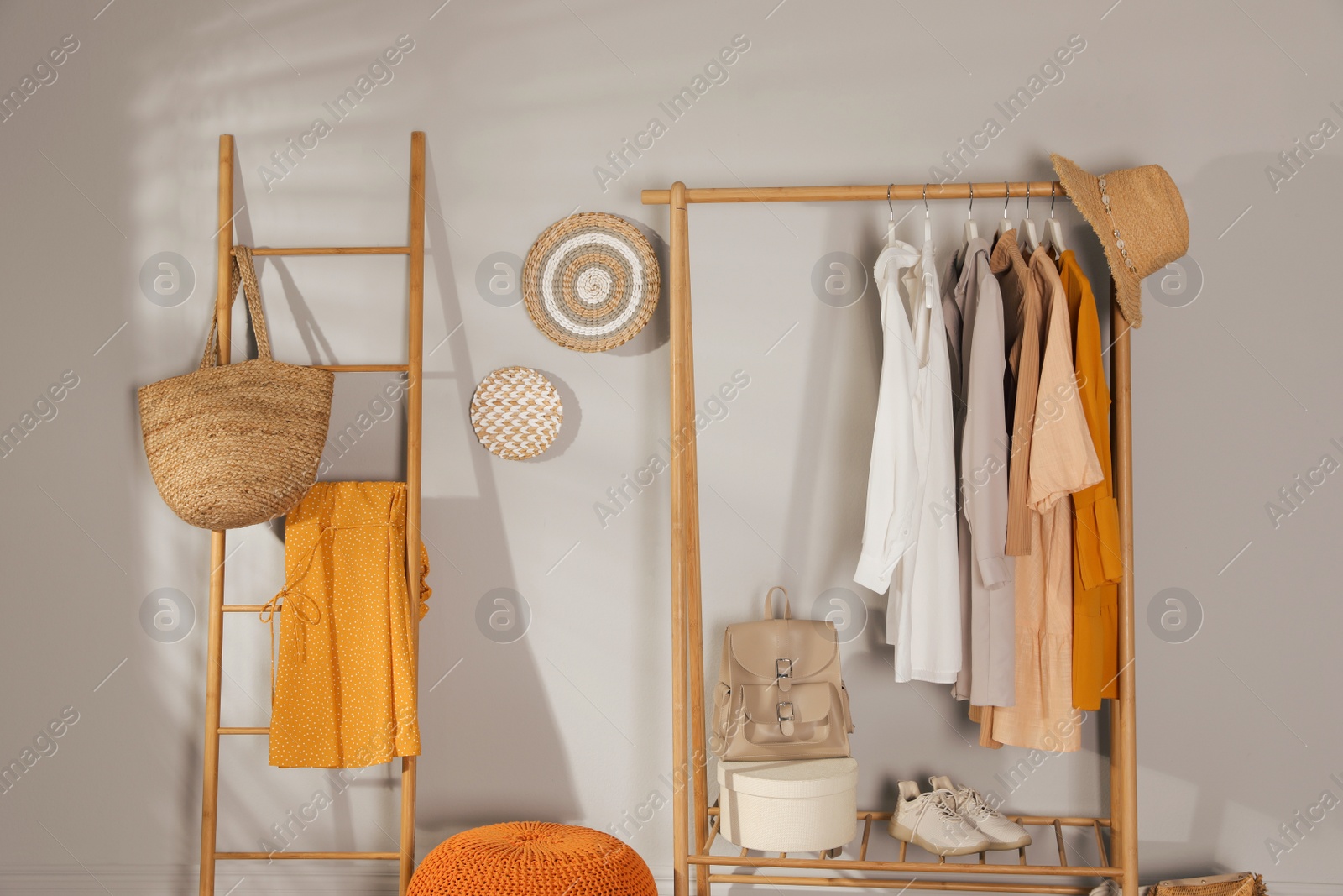 Photo of Modern dressing room interior with stylish clothes, shoes and backpack