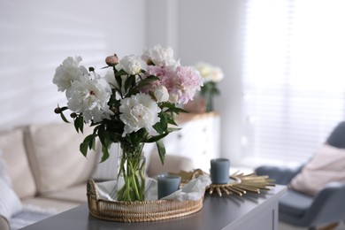 Photo of Bouquet of beautiful peony flowers on table indoors. Space for text