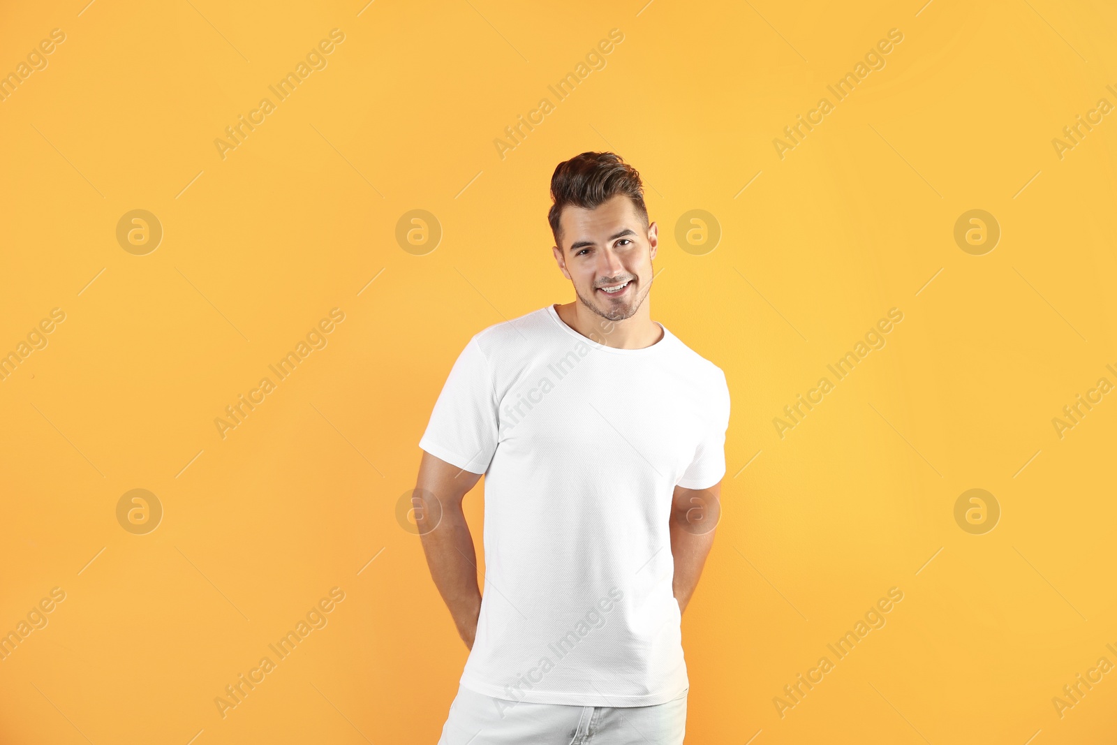 Photo of Young man in t-shirt on color background. Mockup for design