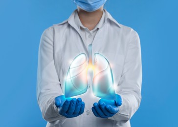 Image of Doctor demonstrating digital image of human lungs on light blue background, closeup