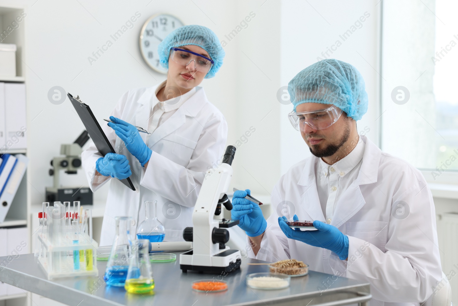 Photo of Quality control. Food inspectors checking safety of products in laboratory