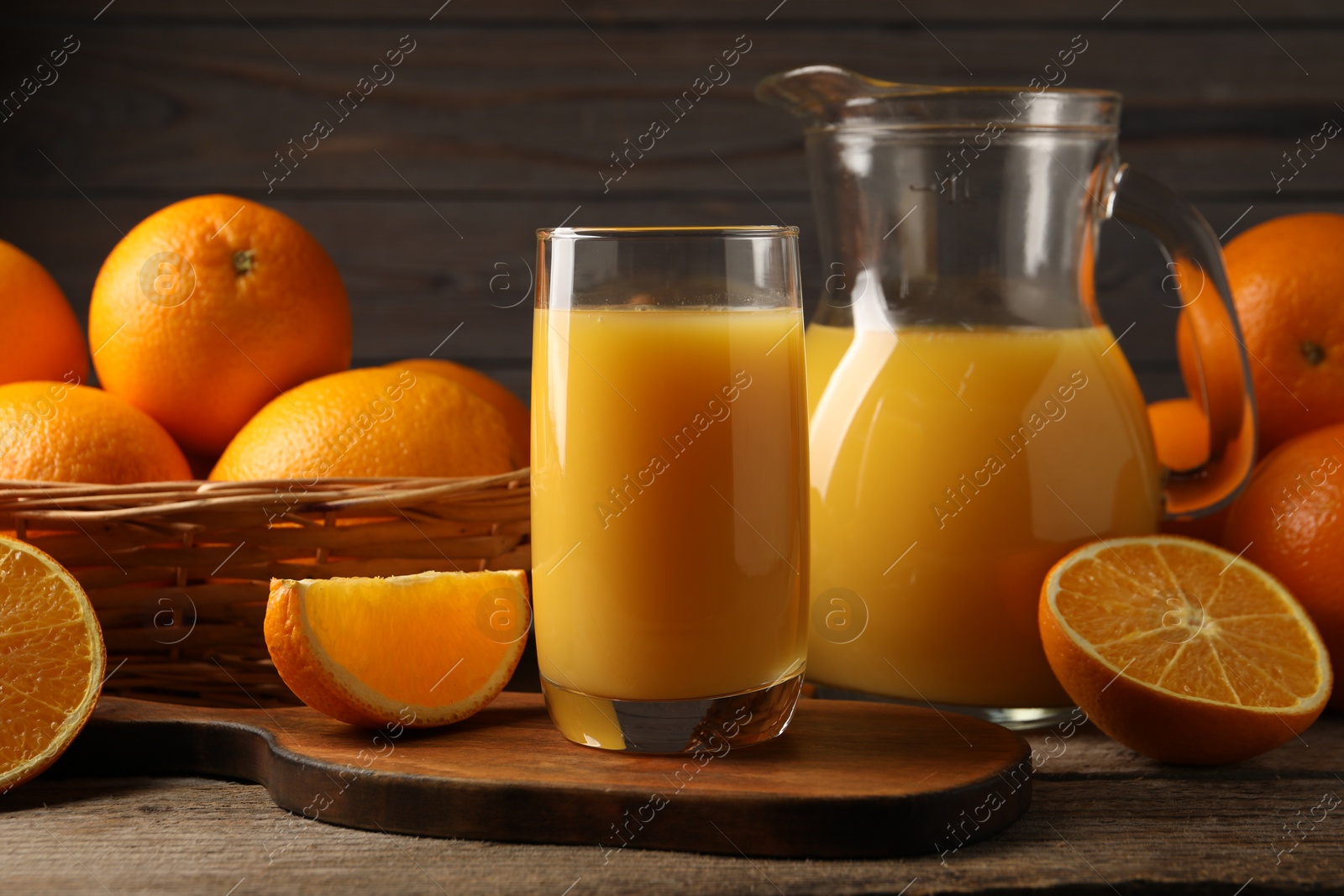 Photo of Tasty fresh oranges and juice on wooden table