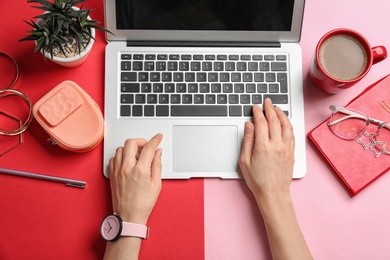 Photo of Blogger with laptop, coffee and different accessories on color background, top view