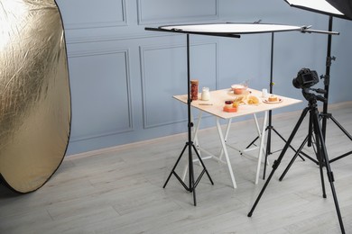 Professional equipment and composition with delicious desserts on wooden table in studio. Food photography