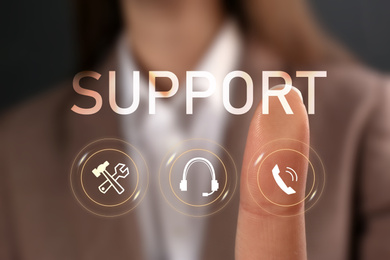 Image of Woman pointing at icon on virtual screen, closeup. Technical support service