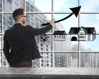 Image of Real estate agent demonstrating prices at housing market. Man pointing on graph illustration