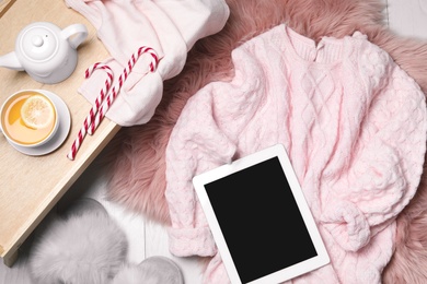 Photo of Flat lay composition with soft knitted sweater on white wooden background