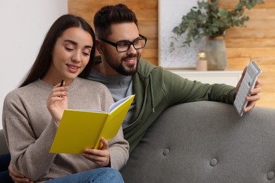 Young couple discussing family budget at home