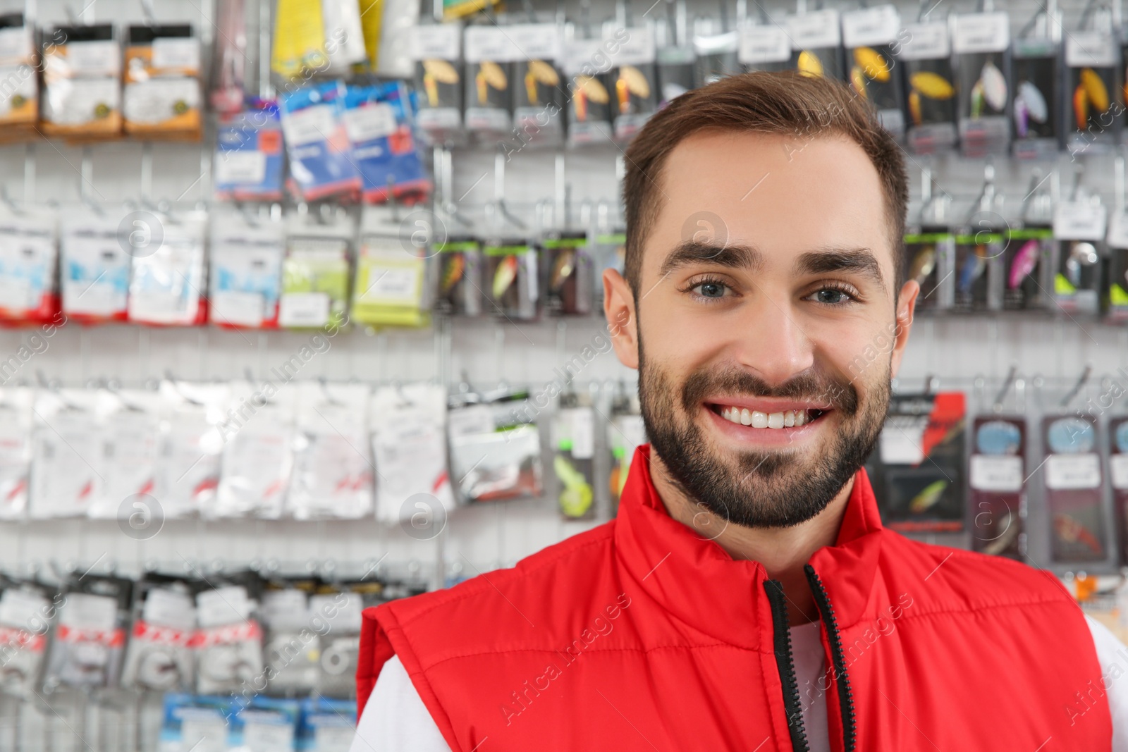 Photo of Portrait of salesman in fishing shop. Space for text