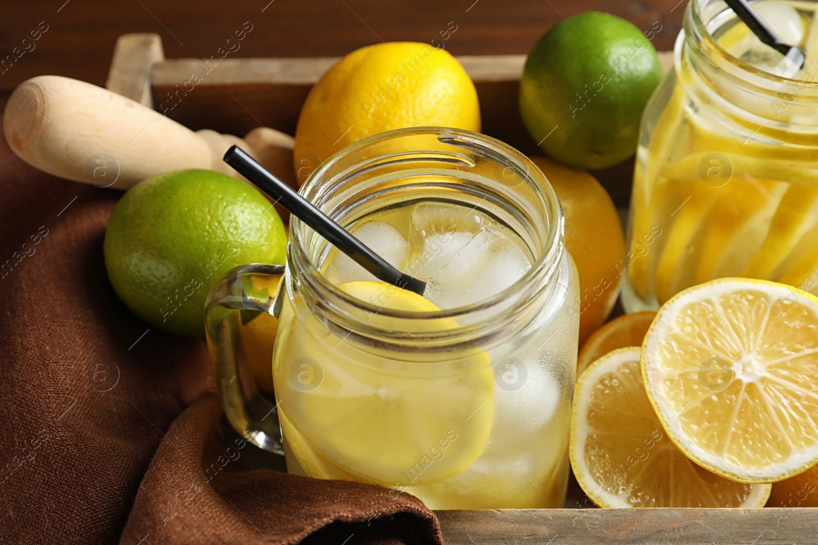 Photo of Mason jars with natural lemonade in wooden crate