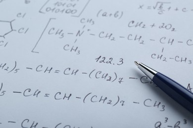 Photo of Sheet of paper with different chemical formulas and pen, closeup