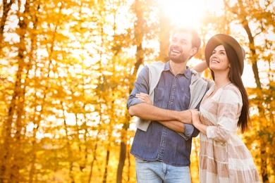 Photo of Happy couple spending time in sunny park. Autumn walk