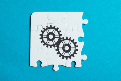 Image of Teamwork concept. White puzzle pieces on turquoise background, top view