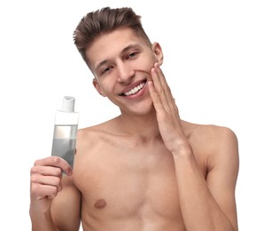 Photo of Handsome man applying lotion onto his face on white background
