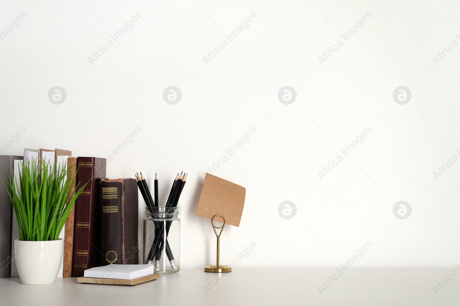 Photo of Comfortable workplace with white desk near wall at home