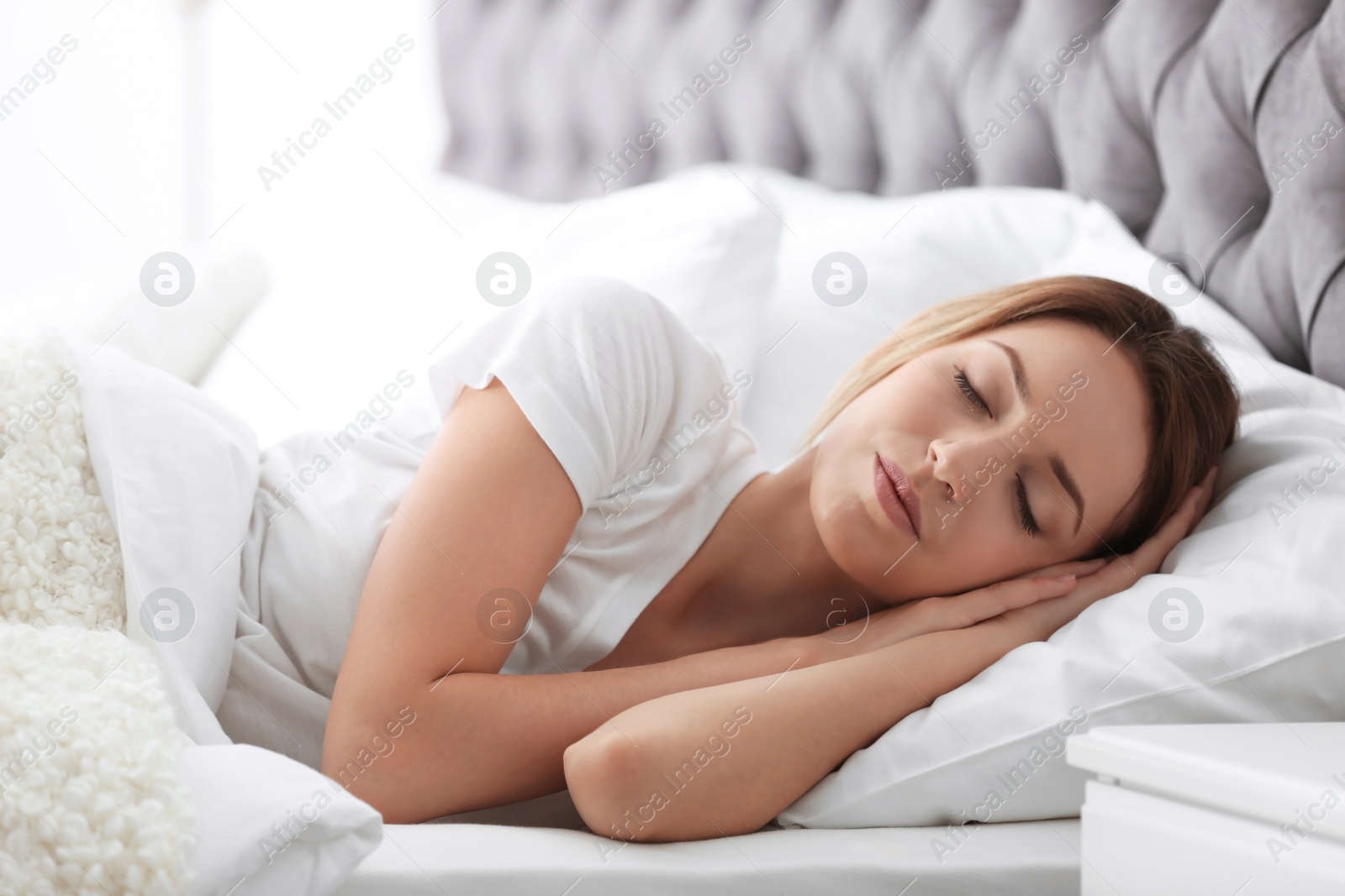 Photo of Young beautiful woman sleeping in bed at home. Early morning