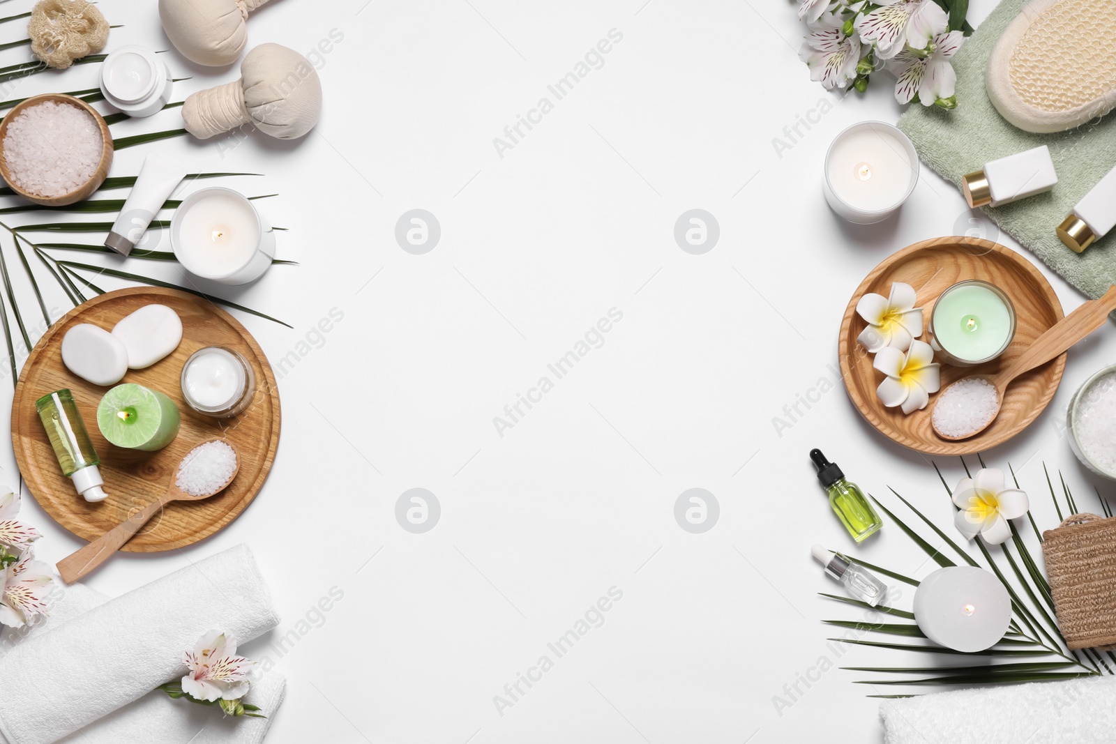 Photo of Flat lay composition with spa essentials on white background. Space for text