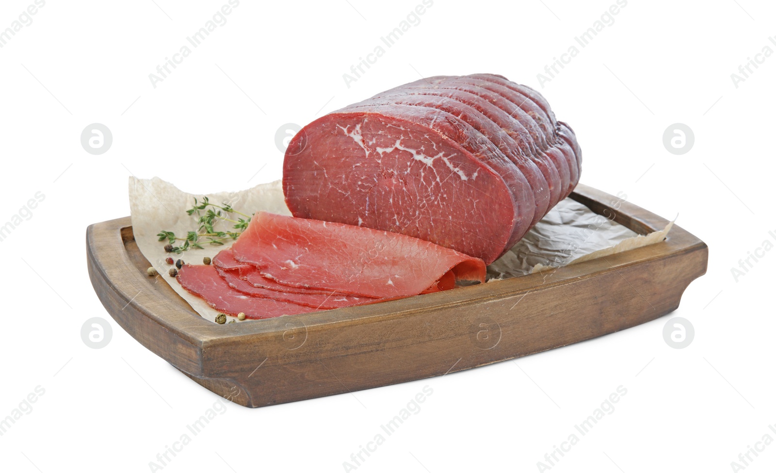 Photo of Tasty fresh dry bresaola, peppercorns and thyme isolated on white