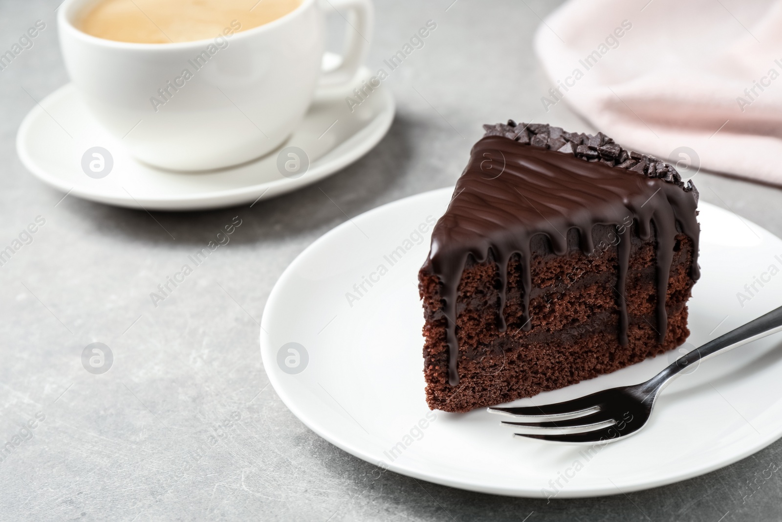 Photo of Delicious chocolate cake on light grey table