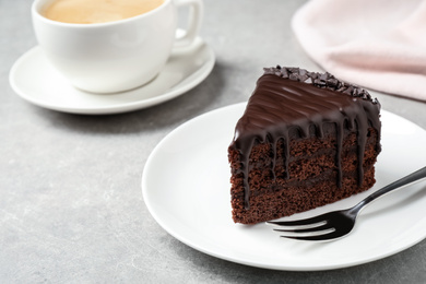Photo of Delicious chocolate cake on light grey table