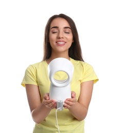 Woman enjoying air flow from portable fan on white background. Summer heat