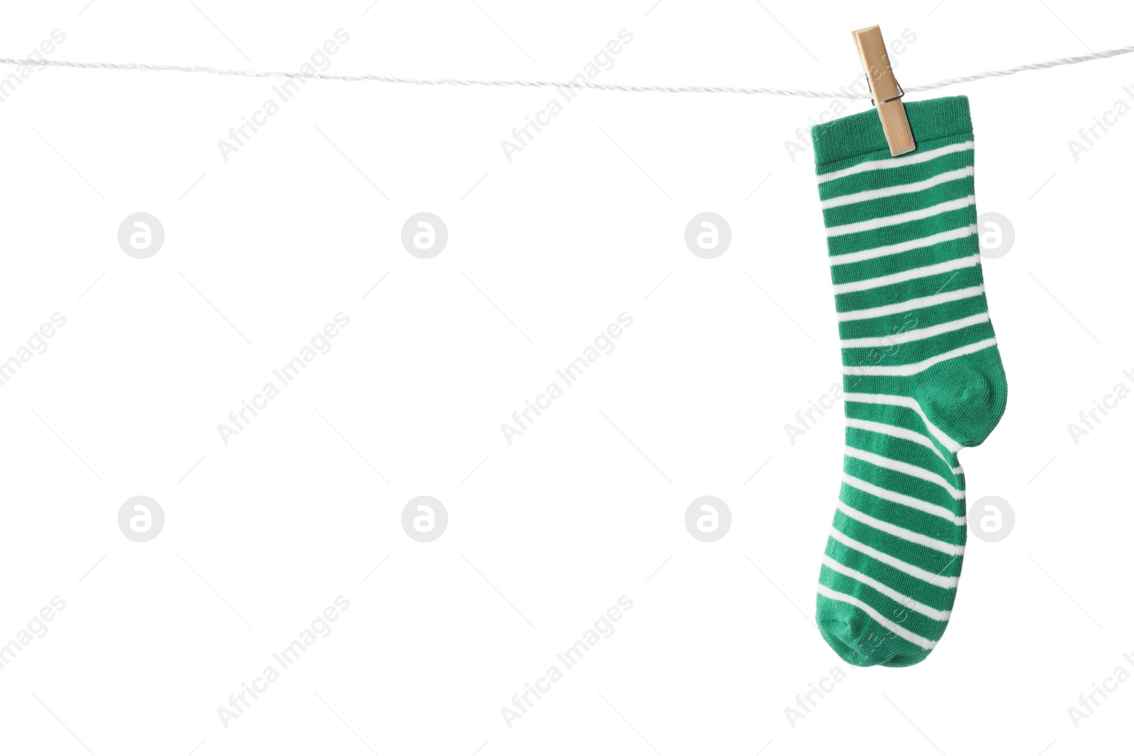 Photo of Cute child sock on laundry line against white background