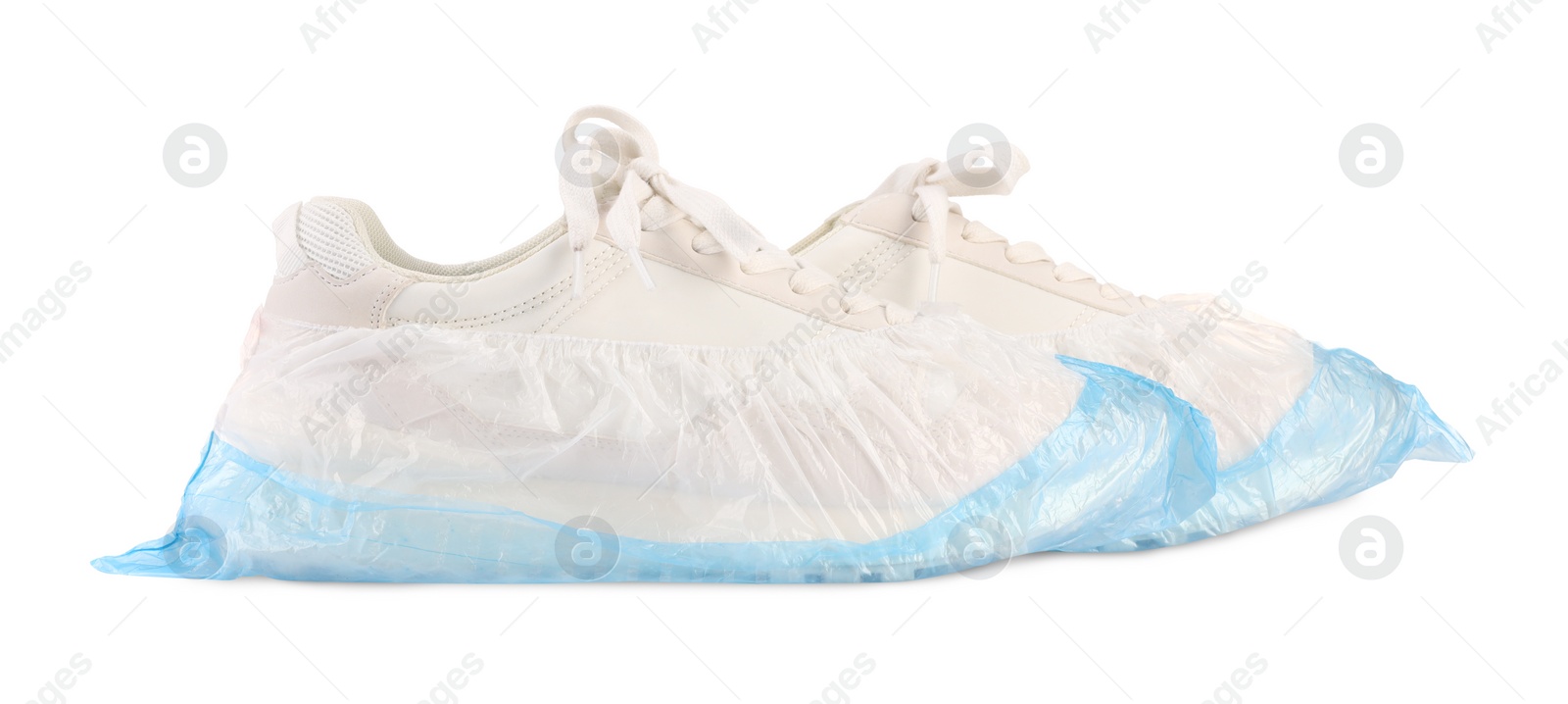 Photo of Sneakers in shoe covers isolated on white