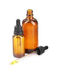 Photo of Glass bottles and pipette with tincture isolated on white