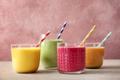 Photo of Glasses with delicious detox smoothies on table