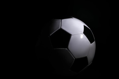 One soccer ball on black background. Sports equipment