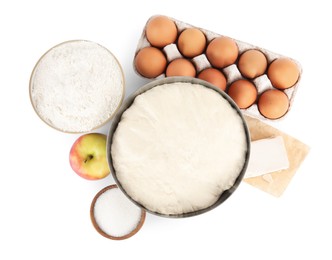 Fresh yeast dough and ingredients for cake on white background, top view