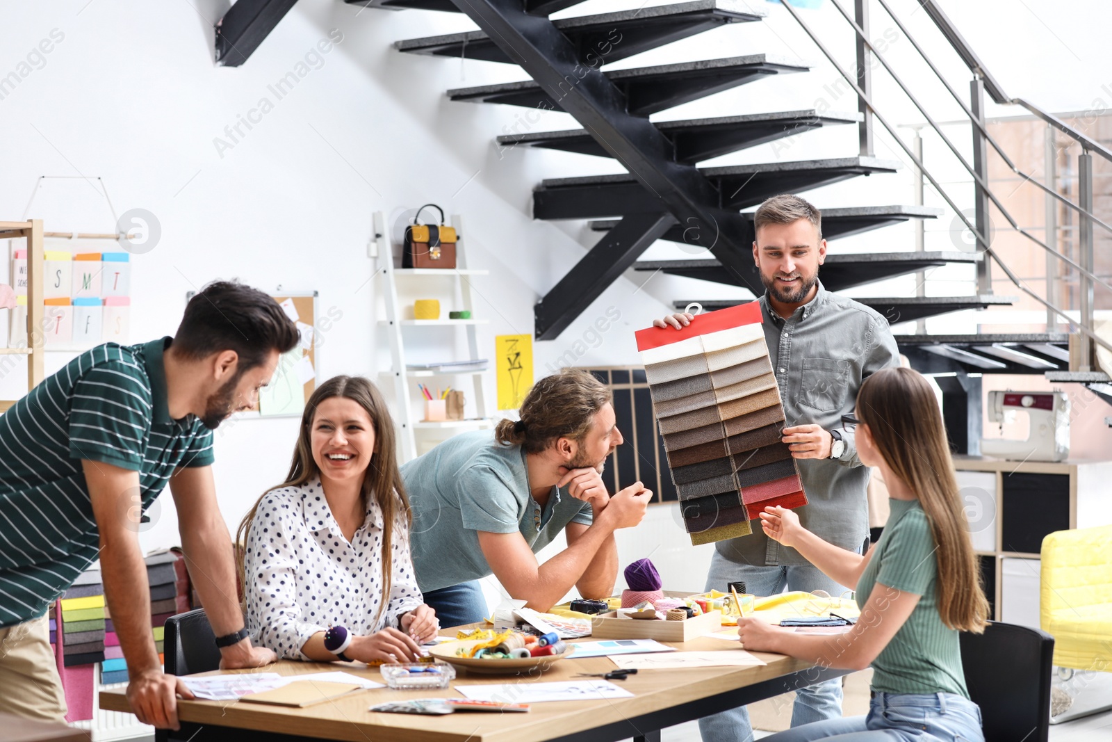 Photo of Fashion designers creating new clothes in studio