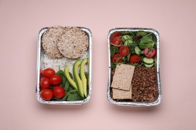 Photo of Containers with different fresh products on pink background, flat lay