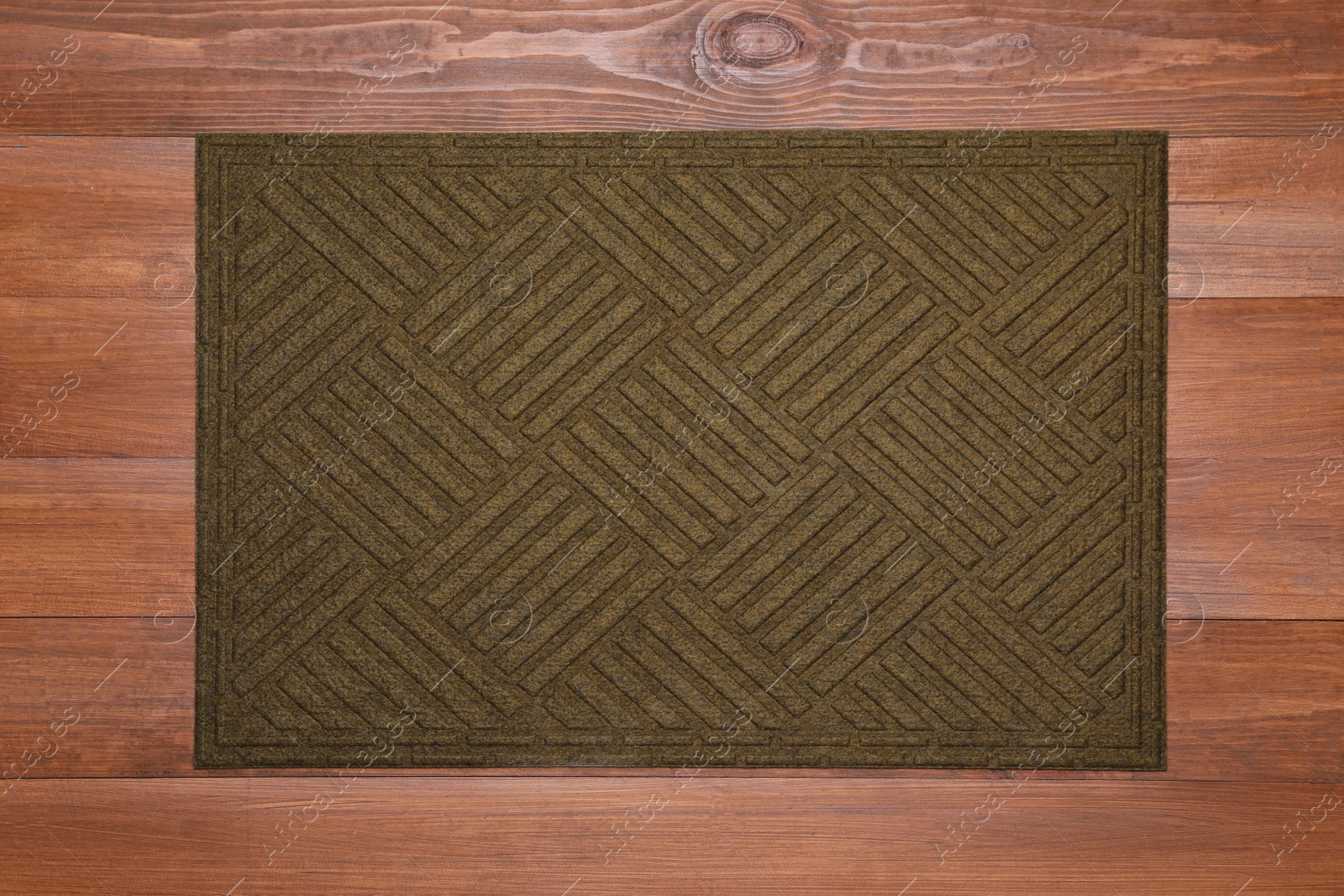 Photo of New clean door mat on wooden floor, top view
