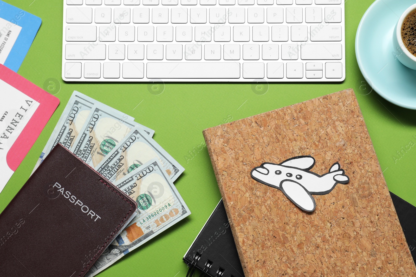 Photo of Flat lay composition with passport, dollars and keyboard on green table. Business trip