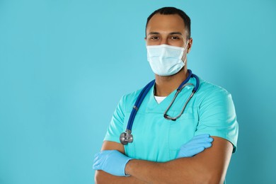 Photo of Doctor or medical assistant (male nurse) with protective mask and stethoscope on turquoise background. Space for text