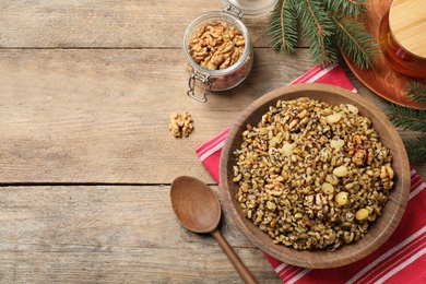 Photo of Traditional Christmas slavic dish kutia served on wooden table, flat lay. Space for text